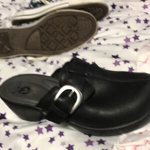 Black crocks with buckle studs on the side